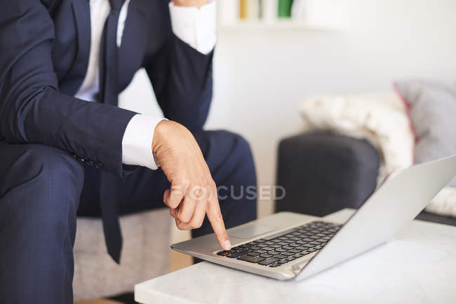 Mid section of businessman using laptop — Stock Photo