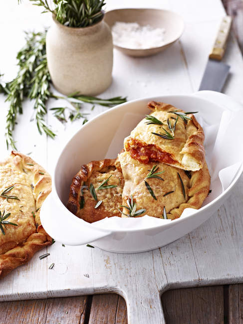 Pork belly and porcini calzone, in white serving bowl — Stock Photo