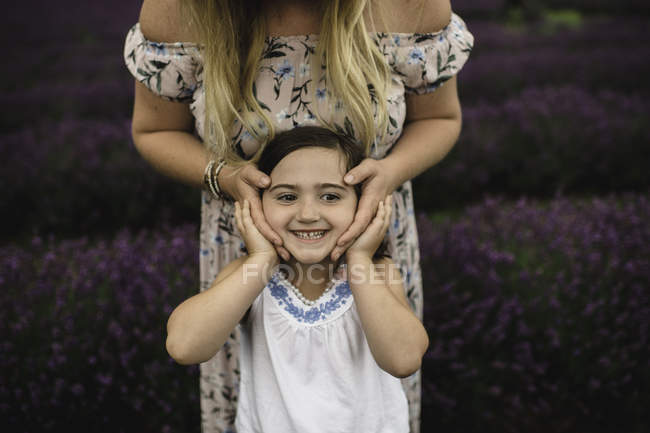 Mother and daughter playing in lavender field — Stock Photo
