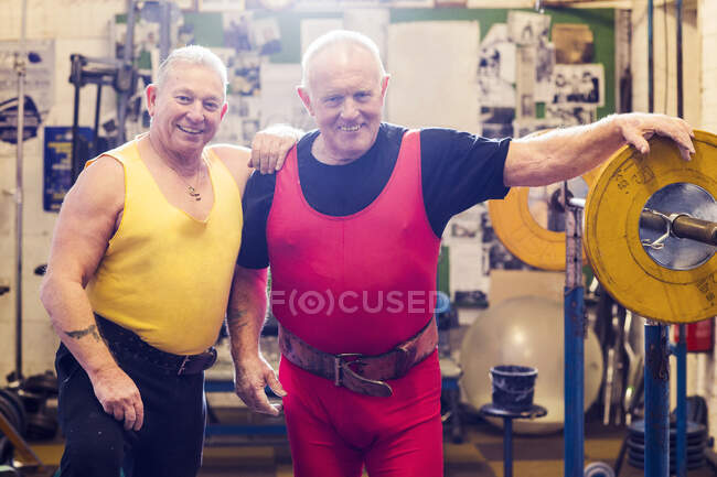 Portrait of two senior male powerlifters in gym — Stock Photo