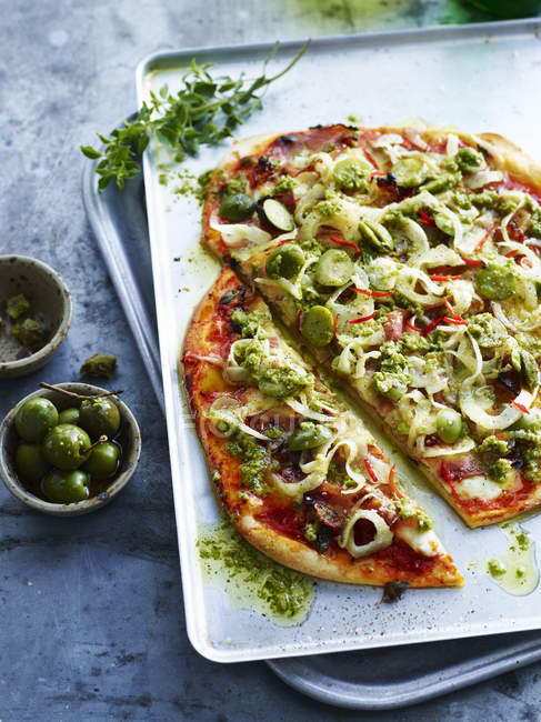 Sliced guancaille and green olive pizza, close-up — Stock Photo