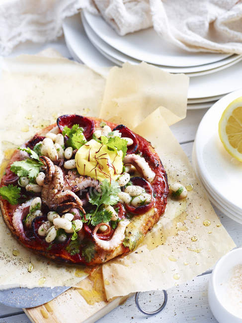 White bean, chorizo and octopus pizza, close-up — Stock Photo