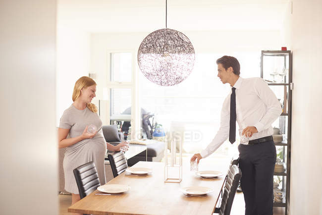 Pregnant couple laying dining table — Stock Photo