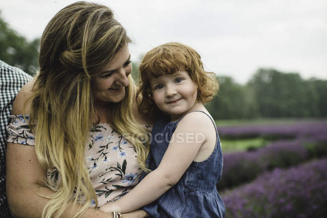 Mother and daughter playing in lavender field — Stock Photo