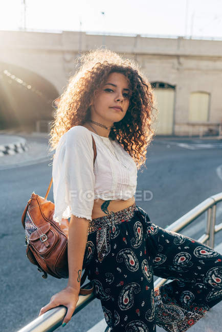 Young woman on street railing, Milan, Italy — Stock Photo