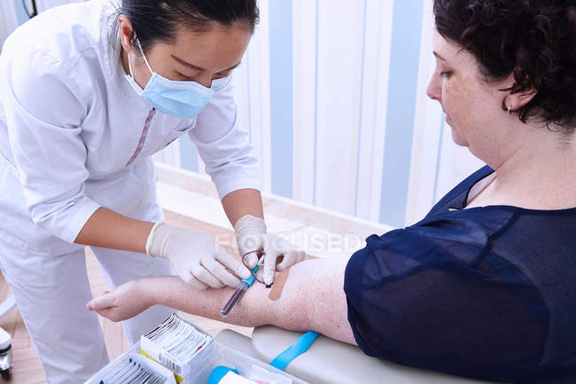 Professionnel médical effectuant un test sanguin à l'hôpital — Photo de stock
