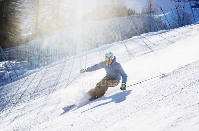 Sciatore che scende sulla collina di montagna — Foto stock