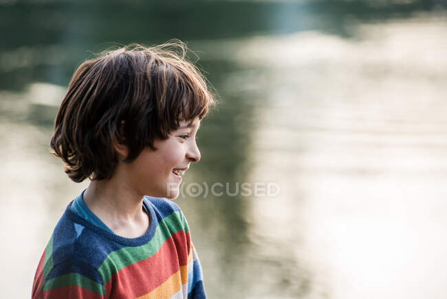 Happy boy by river, Calolziocorte, Lombardy, Italy — Stock Photo