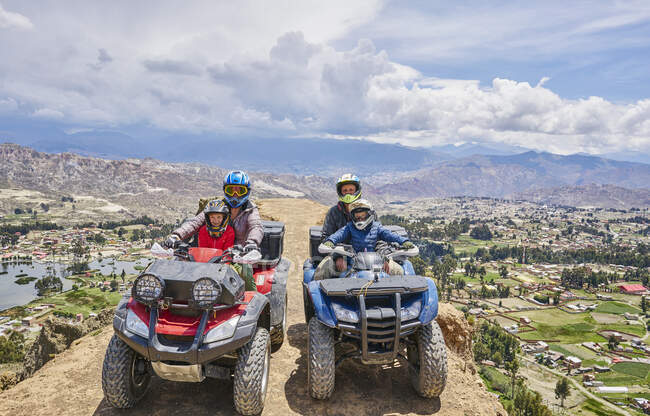Family on top of mountain, using quad bikes, La Paz, Bolivia, South America — Stock Photo