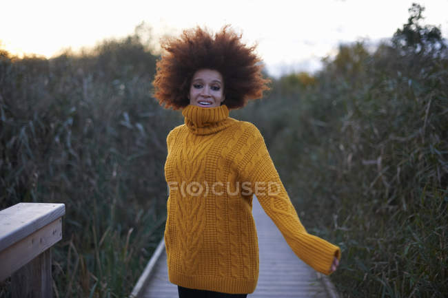 Portrait of young woman walking along rural pathway — Stock Photo