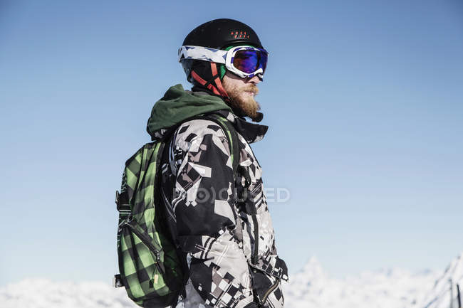 Portrait of skier with backpack looking away — Stock Photo