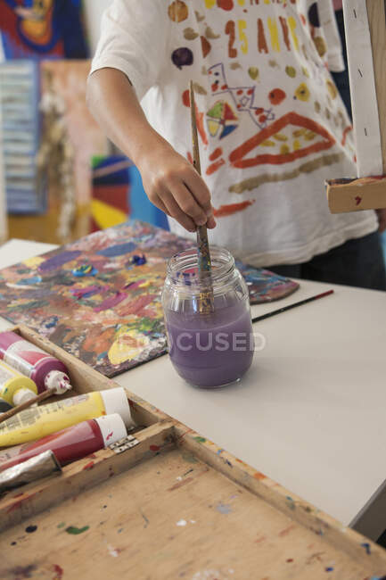 Cropped view of boy painting — Stock Photo