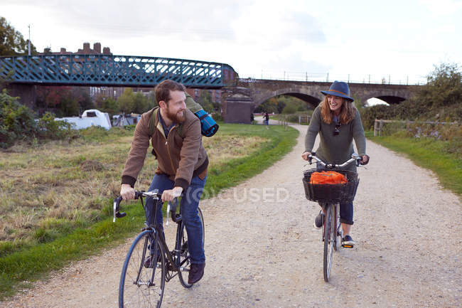 Couple enjoying cycling on marshes — Stock Photo