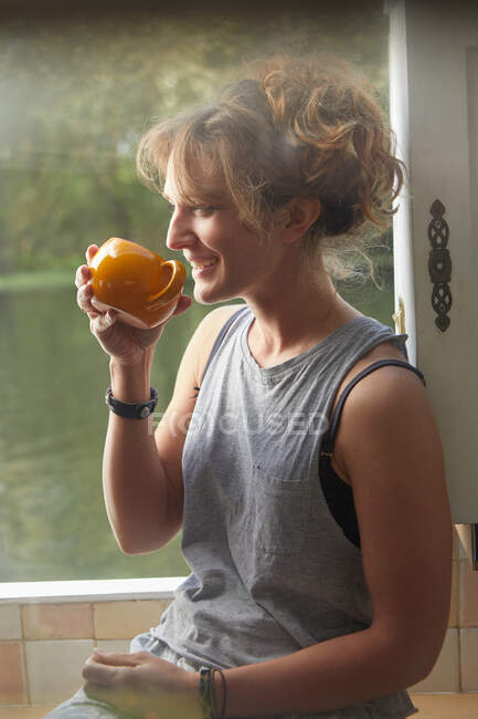 Woman having coffee on canal boat — Stock Photo