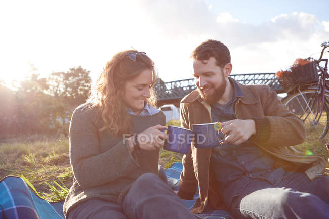 Couple enjoying coffee break on marshes — Stock Photo
