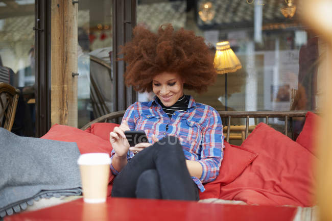 Mujer en la cafetería con teléfono móvil - foto de stock