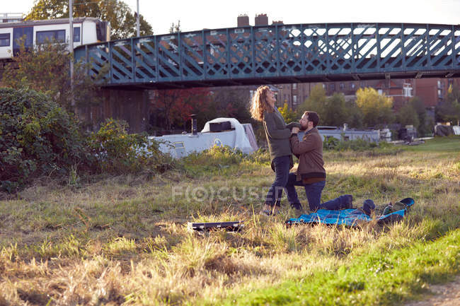 Man proposing to woman on marshes — Stock Photo
