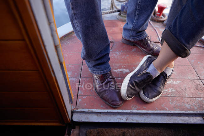 Couple's feet on canal boat — Stock Photo