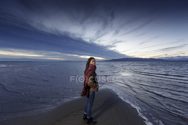 Portrait of young woman on beach at dusk — Stock Photo
