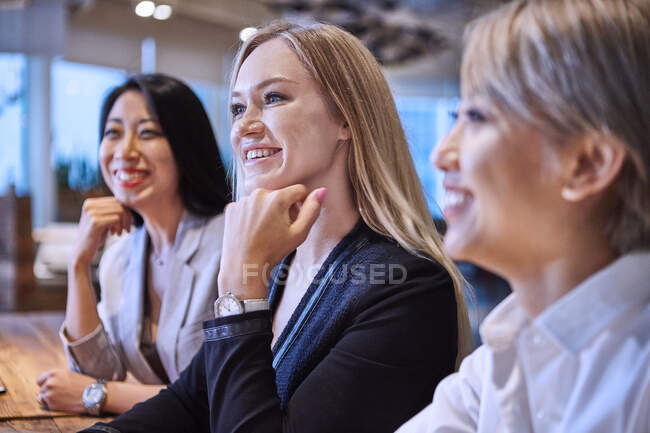 Friends side by side looking away smiling — Stock Photo