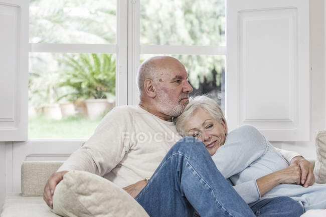 Casal de idosos relaxando juntos no sofá — Fotografia de Stock