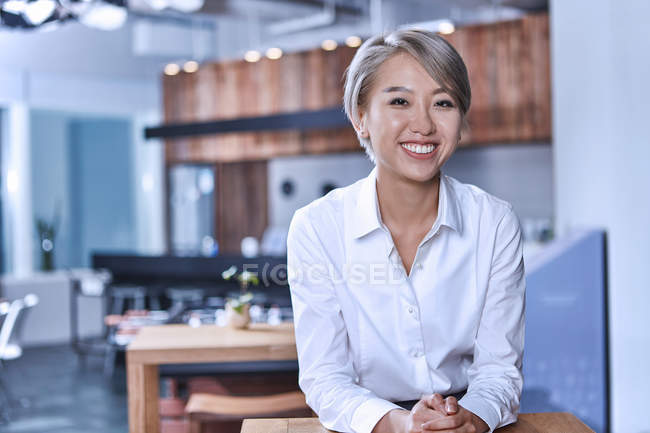 Portrait of short haired woman smiling at camera — Stock Photo