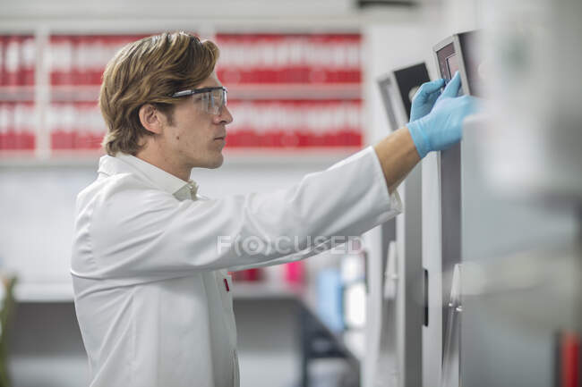 Male worker in thread factory, using touch screen — Stock Photo