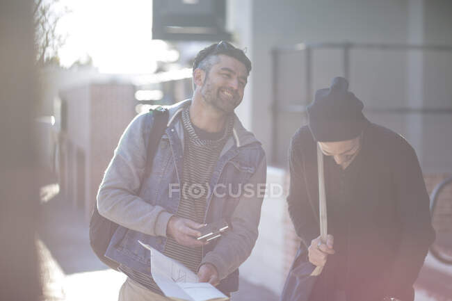 Two men in street, laughing together — Stock Photo