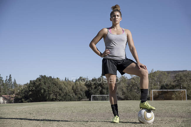 Portrait of woman on football pitch looking at camera — Stock Photo