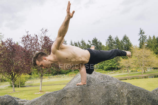 Man balancing on rock with one hand, Seattle, Washington, United States, North America — Stock Photo