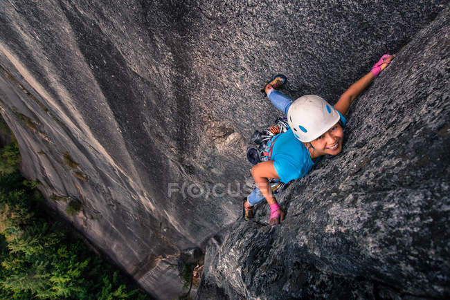 Азиатская женщина, взбирающаяся на отвесную скалу, Сквамиш, Канада, вид под высоким углом — стоковое фото