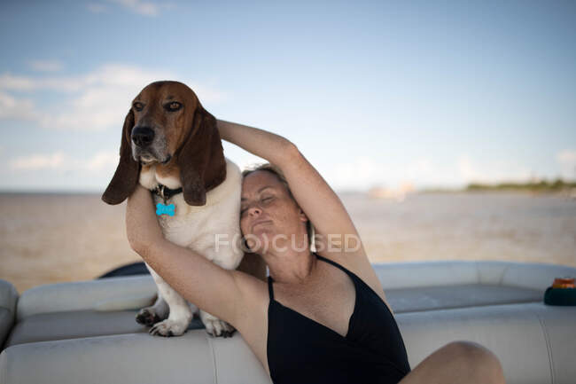 Жінка і домашня собака відпочиває на човні — стокове фото