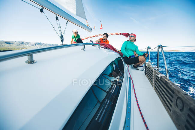 Men and woman yachting near coast, Croatia — Stock Photo