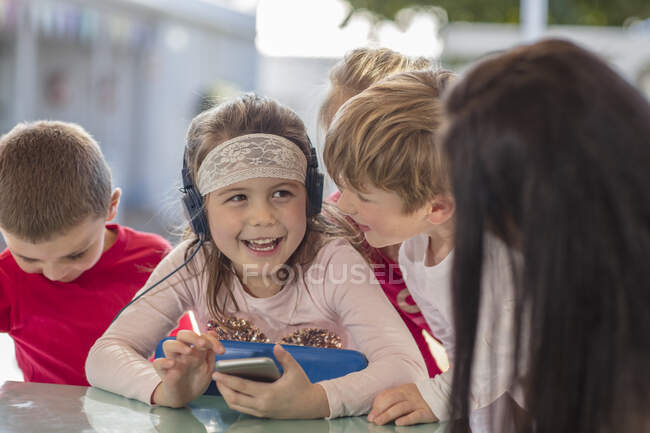 Кейптаун, Південна Африка, маленькі діти на ігровому майданчику слухають музику разом. — стокове фото