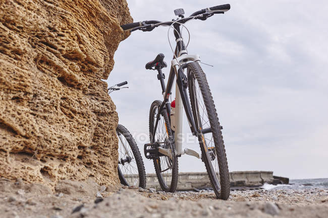 Biciclette appoggiate alla roccia sulla spiaggia, Odessa, Oblast 'di Odeska, Ucraina, Europa — Foto stock