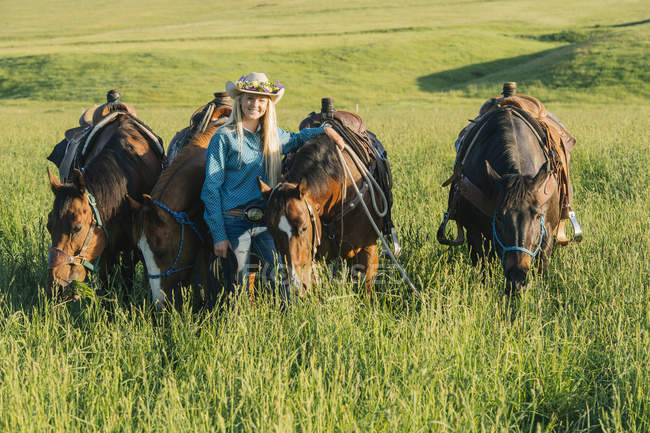 Retrato de menina adolescente com quatro cavalos — Fotografia de Stock