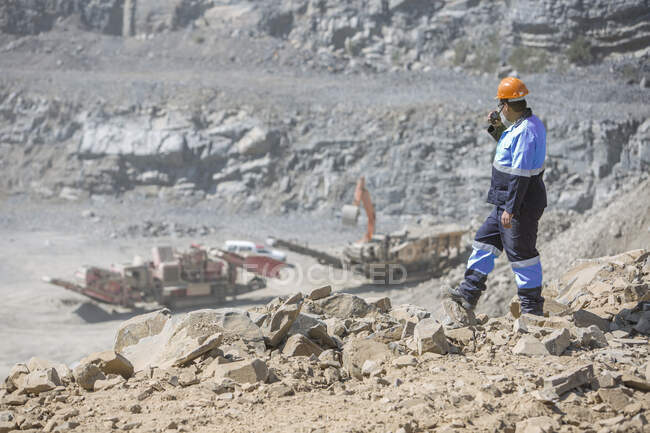 Quarry worker in quarry, talking into walkie talkie — Stock Photo