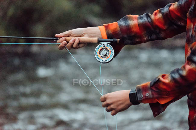 Cropped view of man fishing — Stock Photo