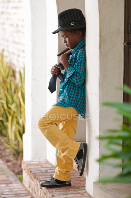 Young boy straightening neck tie outdoors — Stock Photo