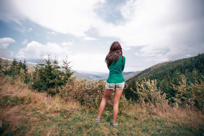 Jeune femme regardant au-dessus des montagnes, Draja, Vaslui, Roumanie, vue arrière — Photo de stock