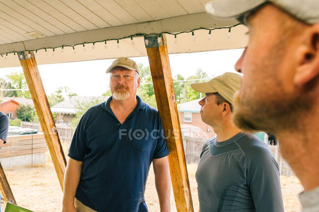 Electricians having discussion in porch — Stock Photo