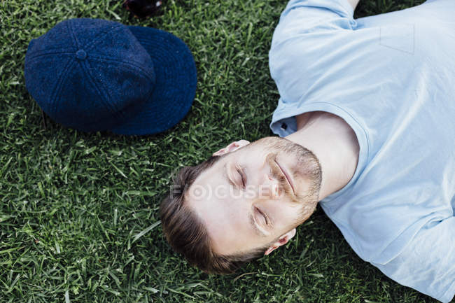 Вид сверху на спящего человека на траве — стоковое фото