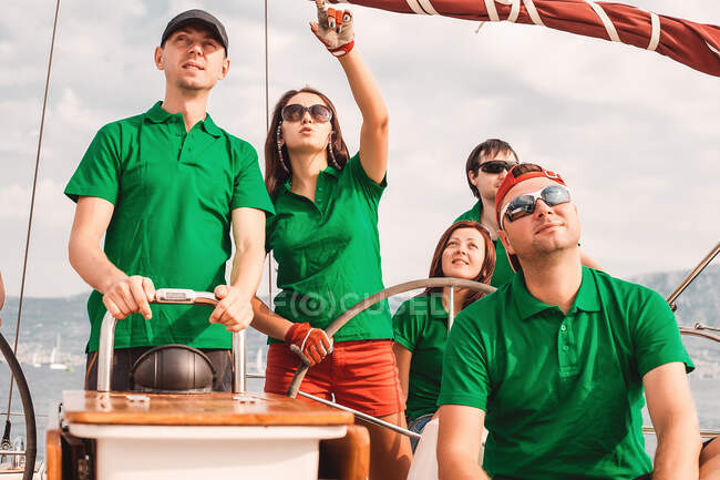 Sailing club crewmen sailing sailboat — Stock Photo