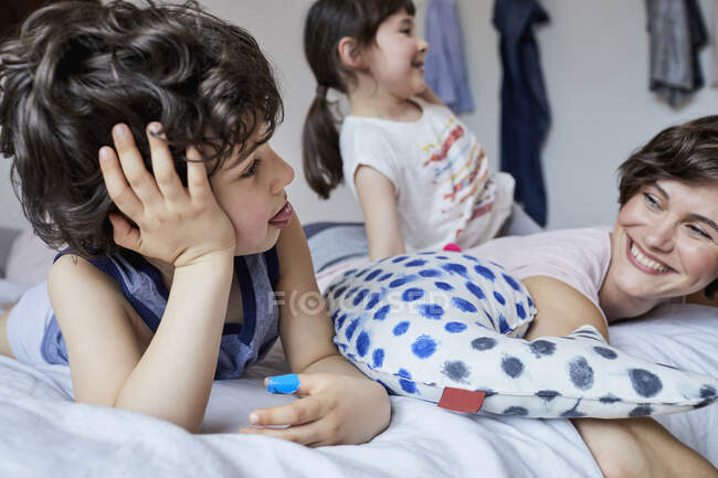 Mother, son and daughter, relaxing in bedroom — Stock Photo