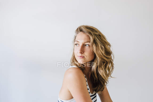 Portrait of young woman, indoors, looking away — Stock Photo
