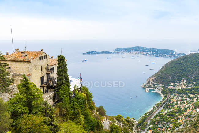 High angle view of rooftops and coastline, Eze, Cote d 'Azur, France — стоковое фото