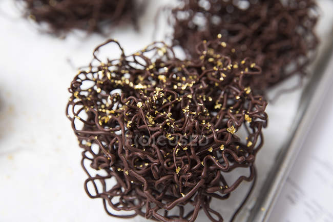 Gold covered chocolate nest cake decoration — Stock Photo