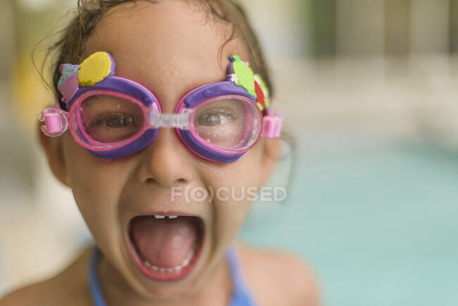 Portrait of girl in goggles by poolside — Stock Photo