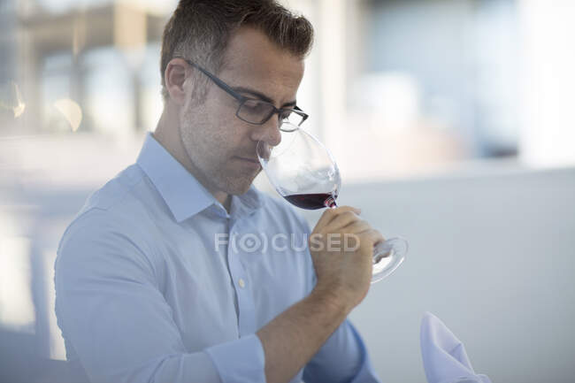Diner in restaurant smelling wine in wineglass — Stock Photo