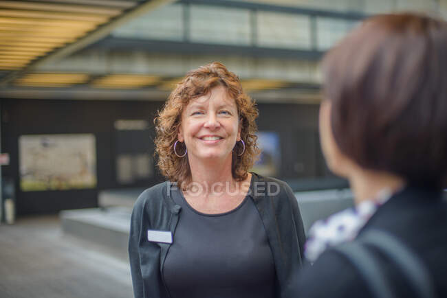 Woman with name tag smiling — Stock Photo